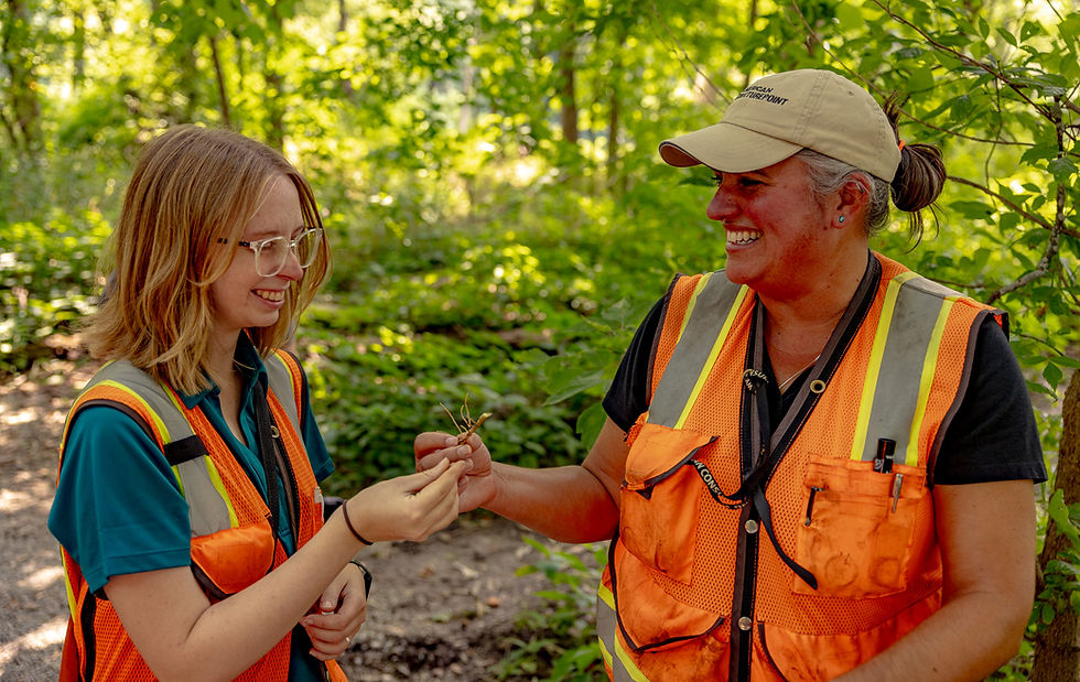 Two employees in safety vests for American Structurepoint careers.