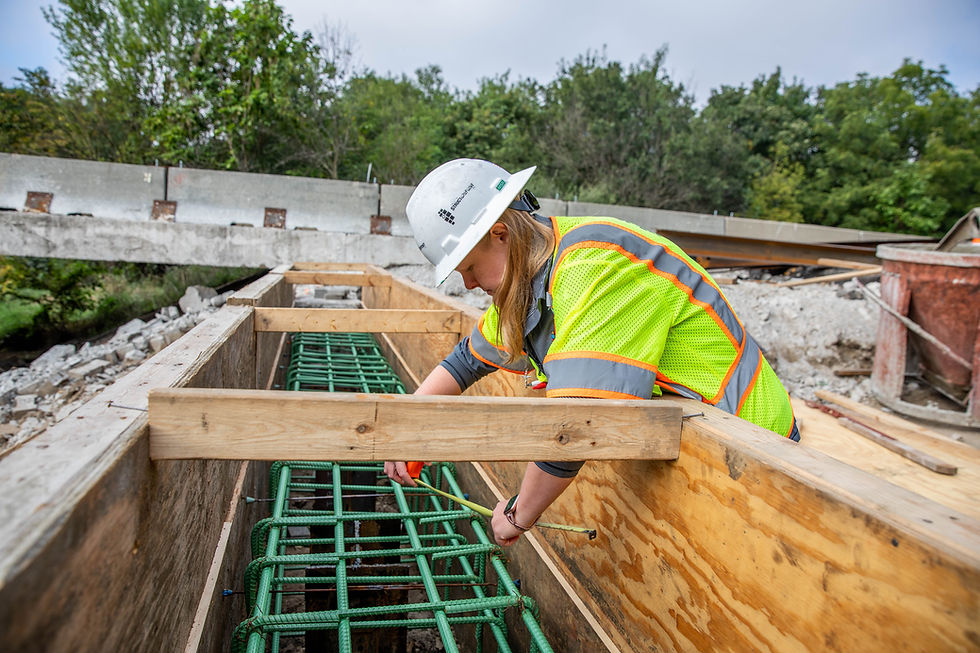 An American Structurepoint worker measures rebar on-site.