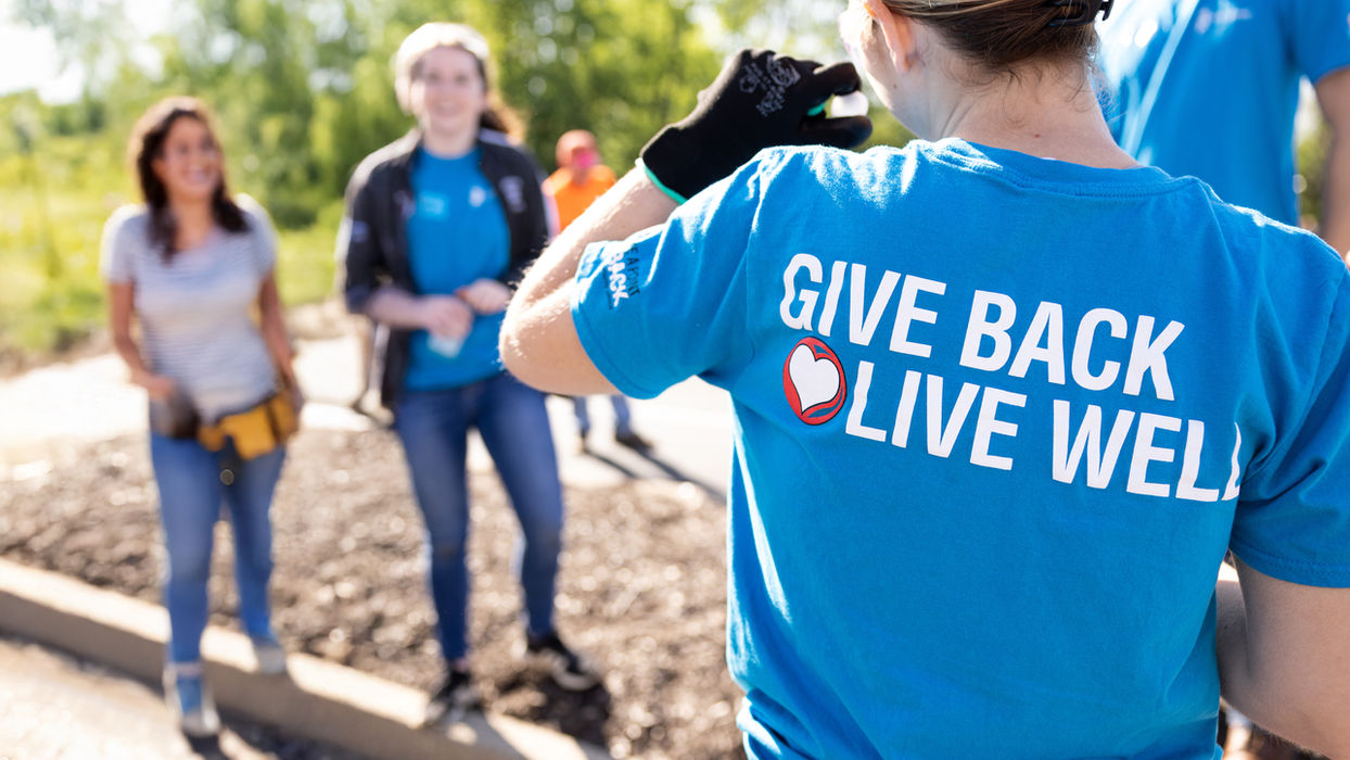 Volunteers with employee benefits and perks giving back