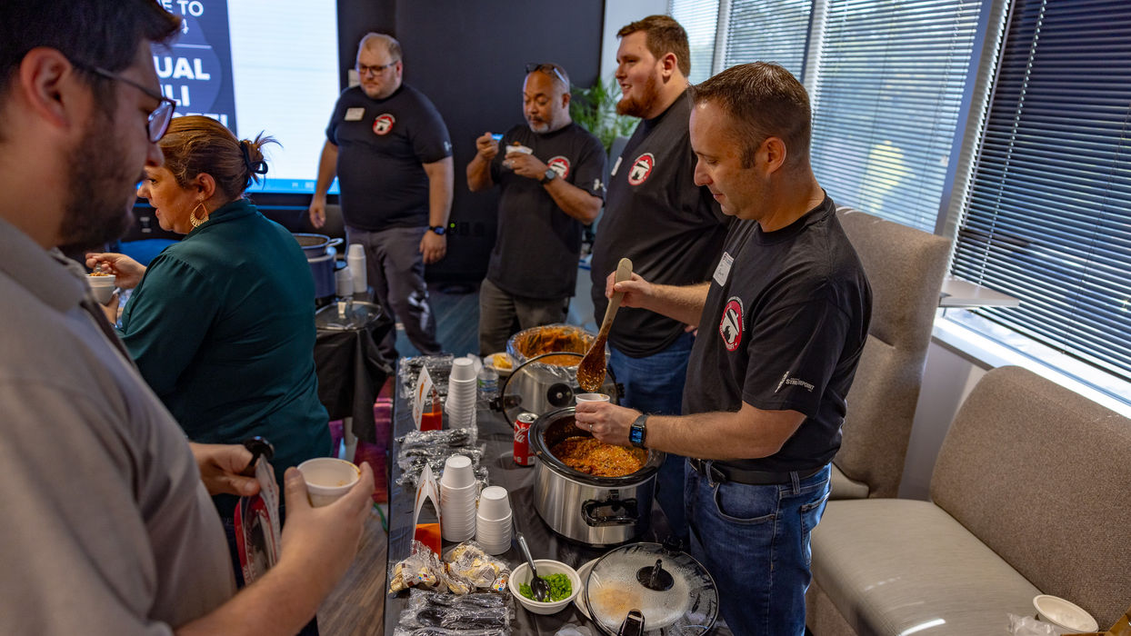 Office team enjoying a catered meal as employee benefits and perks