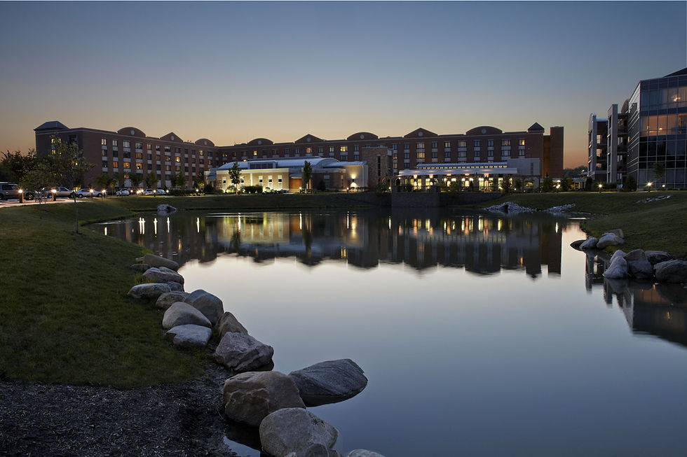 Large brick building and civil engineering services at dusk.