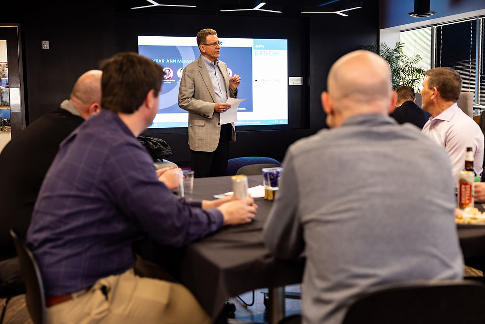 Presenter discussing employee benefits and perks to a group.