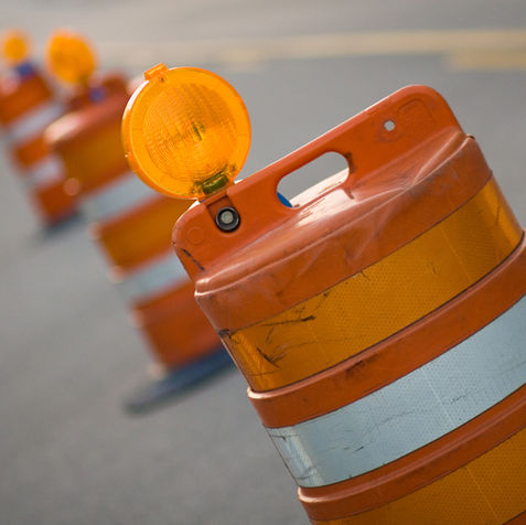 Row of traffic barrels for inspection services.