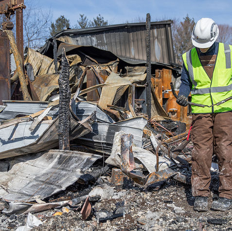 Engineer inspecting site damage for American Structurepoint services.